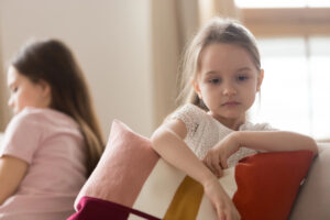 Child looking off into the distance while holding a pillow
